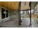 Covered outdoor patio featuring a built-in bench, dining set, and access to a well-maintained backyard at 6530 W 26Th Ave, Edgewater, CO 80214