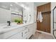 Modern bathroom featuring a double vanity, wood accent wall, and walk-in shower at 10123 Zeno St, Commerce City, CO 80022
