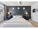 Modern bedroom featuring a dark accent wall, stylish decor, and a comfortable, well-lit space at 10123 Zeno St, Commerce City, CO 80022