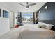 Bright bedroom with a large window, stylish chair, and a comfortable bed with decorative pillows at 10123 Zeno St, Commerce City, CO 80022