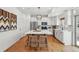 Spacious kitchen with stainless steel appliances, island and modern lighting at 10123 Zeno St, Commerce City, CO 80022