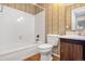 Bathroom with tub, toilet and wood-toned vanity at 16846 E Kenyon Dr, Aurora, CO 80013