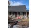 Modest single-story home with covered front porch and straightforward design at 305 Strong St, Brighton, CO 80601