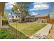 Spacious backyard with brick home, lush green lawn, mature trees, and an inviting patio seating area at 882 E Briarwood Cir, Centennial, CO 80122