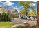 Serene backyard setting with lush landscaping, mature trees, a cozy shed, and comfortable seating area at 882 E Briarwood Cir, Centennial, CO 80122