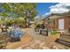 Inviting backyard with stone pathways, raised garden beds, egg chair, and outdoor fireplace, perfect for relaxation at 882 E Briarwood Cir, Centennial, CO 80122
