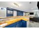 Basement bar with a wooden countertop and seating at 882 E Briarwood Cir, Centennial, CO 80122