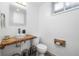 Modern bathroom featuring a wooden countertop sink, decorative mirror, and stylish fixtures and decor at 882 E Briarwood Cir, Centennial, CO 80122