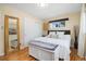 Bedroom featuring hardwood floors, a closet, large windows, and a white storage bench at 882 E Briarwood Cir, Centennial, CO 80122