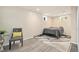 Basement bedroom with plank flooring, large bed, and decorative chair with windows offering ample natural light at 882 E Briarwood Cir, Centennial, CO 80122