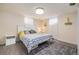 Basement bedroom with neutral walls, a modern-patterned bedspread, and a matching bedside table at 882 E Briarwood Cir, Centennial, CO 80122