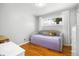 Cozy bedroom with hardwood floors and a daybed beneath a sunny window at 882 E Briarwood Cir, Centennial, CO 80122