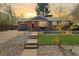 Charming brick home with a cozy front porch and well-maintained front yard landscaping at 882 E Briarwood Cir, Centennial, CO 80122