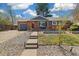 Charming brick home with a cozy front porch and well-maintained front yard landscaping at 882 E Briarwood Cir, Centennial, CO 80122