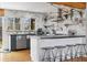 A well-lit kitchen with marble backsplash, stainless steel appliances and a breakfast bar with stools at 882 E Briarwood Cir, Centennial, CO 80122