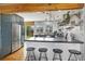Modern kitchen featuring stainless steel appliances, marble backsplash, breakfast bar and view to backyard at 882 E Briarwood Cir, Centennial, CO 80122