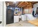 Unfinished basement laundry room with washer, dryer, utility sink, and ample storage space at 882 E Briarwood Cir, Centennial, CO 80122