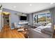 Comfortable living room with wood floors, gray walls, and large window with neighborhood views at 882 E Briarwood Cir, Centennial, CO 80122