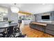 Open-concept living area featuring hardwood floors, stylish lighting, and a seamless flow to the kitchen at 882 E Briarwood Cir, Centennial, CO 80122