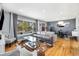 Stylish living room with hardwood floors, a large window, and an open view to the dining area at 882 E Briarwood Cir, Centennial, CO 80122