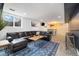 Finished basement with a bar, a modern sofa set on a patterned rug, and a planked wood accent wall at 882 E Briarwood Cir, Centennial, CO 80122
