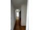 Bright hallway with hardwood floors and skylights providing natural light, connecting the home's living spaces at 6838 Harvest Rd, Boulder, CO 80301