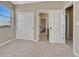 Bedroom with two closets and a view to the bath, featuring neutral paint and carpeting at 14667 Crouch Pl, Parker, CO 80134