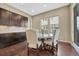 Charming dining area with a round table, upholstered chairs, and large windows for natural light at 14667 Crouch Pl, Parker, CO 80134