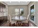 Cozy dining area features a round table, upholstered chairs, and natural light from the adjacent sliding glass door at 14667 Crouch Pl, Parker, CO 80134