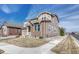 Charming two-story home with stone accents and well-manicured front lawn, located in a desirable neighborhood at 14667 Crouch Pl, Parker, CO 80134