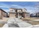Charming two-story home with stone accents, neutral siding, attached garage, and well-manicured lawn at 14667 Crouch Pl, Parker, CO 80134