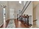 Welcoming entryway with hardwood floors, staircase, console table, and ample natural light at 14667 Crouch Pl, Parker, CO 80134