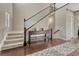 Elegant entryway featuring hardwood floors, staircase with wrought iron railings, and console table at 14667 Crouch Pl, Parker, CO 80134