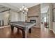 Game room features a pool table and stone fireplace, perfect for entertainment and relaxation at 14667 Crouch Pl, Parker, CO 80134