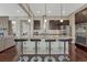 This modern kitchen features a large island with seating, stainless steel appliances, and sleek cabinetry at 14667 Crouch Pl, Parker, CO 80134