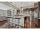 Modern kitchen with spacious island featuring counter seating, stainless appliances, and stone countertops at 14667 Crouch Pl, Parker, CO 80134