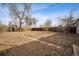 Large, fenced backyard with mature trees, offering plenty of space for outdoor activities and privacy at 1734 Kingston St, Aurora, CO 80010
