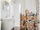 Charming bathroom with a stylish vanity, subway tile surround, and unique shower curtain at 1734 Kingston St, Aurora, CO 80010
