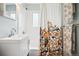 Bright bathroom featuring a floral-themed shower curtain, white vanity, and fresh white tile at 1734 Kingston St, Aurora, CO 80010