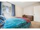 Cozy bedroom featuring a plush bed, natural light from the window, and a dresser for storage at 1734 Kingston St, Aurora, CO 80010