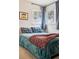 Well-lit bedroom featuring a comfortable bed, bright windows, and neutral decor at 1734 Kingston St, Aurora, CO 80010