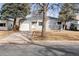 Charming single-story home with a well-maintained lawn and mature trees providing ample shade at 1734 Kingston St, Aurora, CO 80010