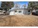Single-story home with a gray exterior, attached one car garage and an established front yard at 1734 Kingston St, Aurora, CO 80010