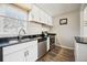 Updated kitchen featuring stainless steel appliances and modern white cabinets at 1734 Kingston St, Aurora, CO 80010