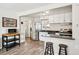 Efficient kitchen with stainless steel appliances, breakfast bar, and sleek black countertops at 1734 Kingston St, Aurora, CO 80010