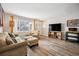 Inviting living room with wood floors, large windows, and comfortable seating arrangement at 1734 Kingston St, Aurora, CO 80010