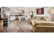 Open living area with wood floors, kitchen bar seating, and comfortable sofas in the Gathering room at 1734 Kingston St, Aurora, CO 80010