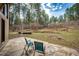 Large flagstone patio with seating overlooking a lush, wooded backyard at 530 Windmill Rd, Castle Rock, CO 80108
