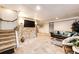 Finished basement featuring a tv and staircase to main floor at 530 Windmill Rd, Castle Rock, CO 80108