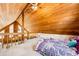Upstairs bedroom with vaulted wood ceilings and staircase overlooking living room at 530 Windmill Rd, Castle Rock, CO 80108